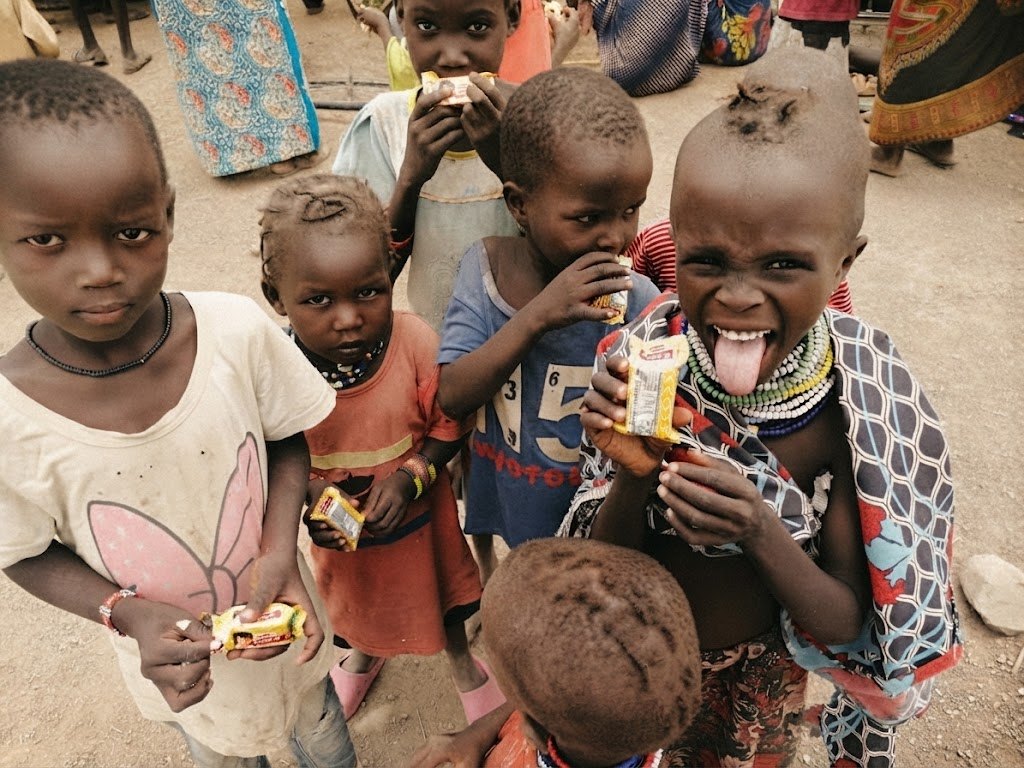 Children in a village receiving food during an outreach distribution